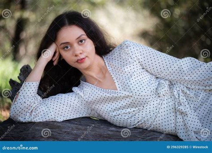 a woman laying on top of a bed next to a man