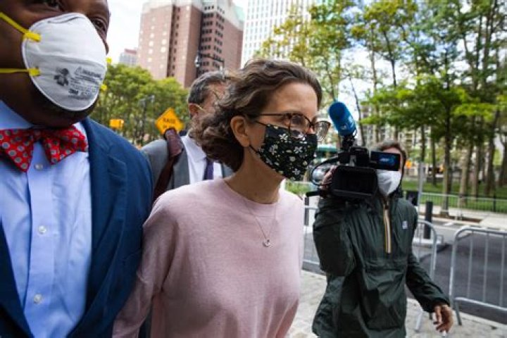Clare Bronfman arrives at federal court, Wednesday, Sept. 30, 2020, in the Brooklyn borough of New York. Bronfman, the Seagram's liquor fortune heir and a wealthy benefactor of Keith Raniere, the disgraced leader of a self-improvement group NXIVM in upstate New York convicted of turning women into sex slaves who were branded with his initials, faces sentencing Wednesday in the federal conspiracy case. (AP Photo/John Minchillo)